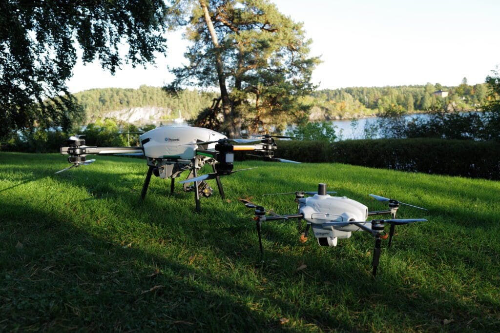 A couple of white drones are on the grass