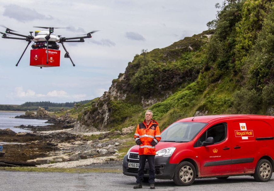 Jura postie Graeme Lindsay collects the mail from drone test flight from Islay.
Royal Mail has launched its latest trial to deliver mail by drone, in collaboration with drone specialists Skyports and Argyll and Bute Council.

The drone flights are running between the remote isles of Islay and Jura in the Inner Hebrides for a month until 26 July, with postal workers loading and unloading mail on both sides for the first time.

The multirotor drone, which can carry payloads of up to 6kg, is the same one used in Royal Mail’s previous trial in Orkney. It will transport mail that is usually taken via ferry in a Royal Mail van.